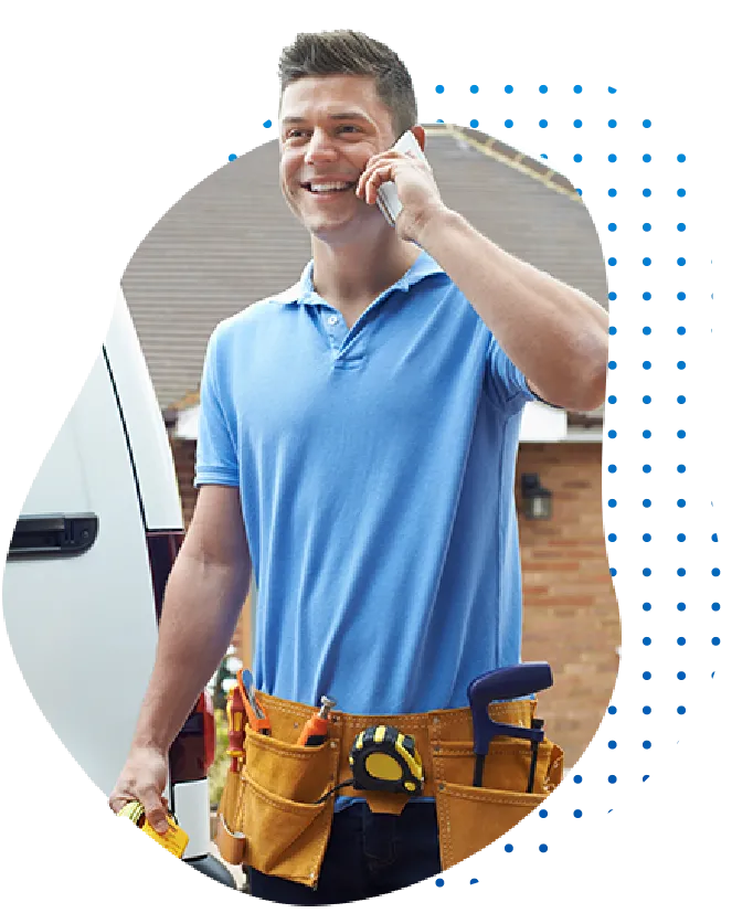 Tradesman smiling while talking on the phone